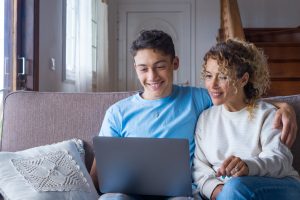 A young man and his mother Attend the first Triage Health Conference to learn tips for using health insurance, how to navigate finances, appealing denials, and employment rights.