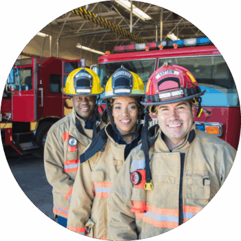 Three members of the fire service standing in a line smiling.