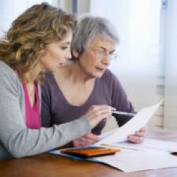 patient advocate helping elderly parent review medical bill